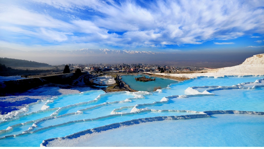 Pammukkale thermal pools with a view of the city and Mountains