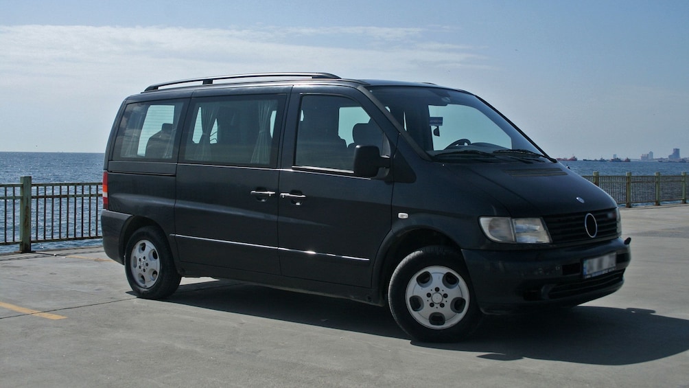 Black van parked near ocean