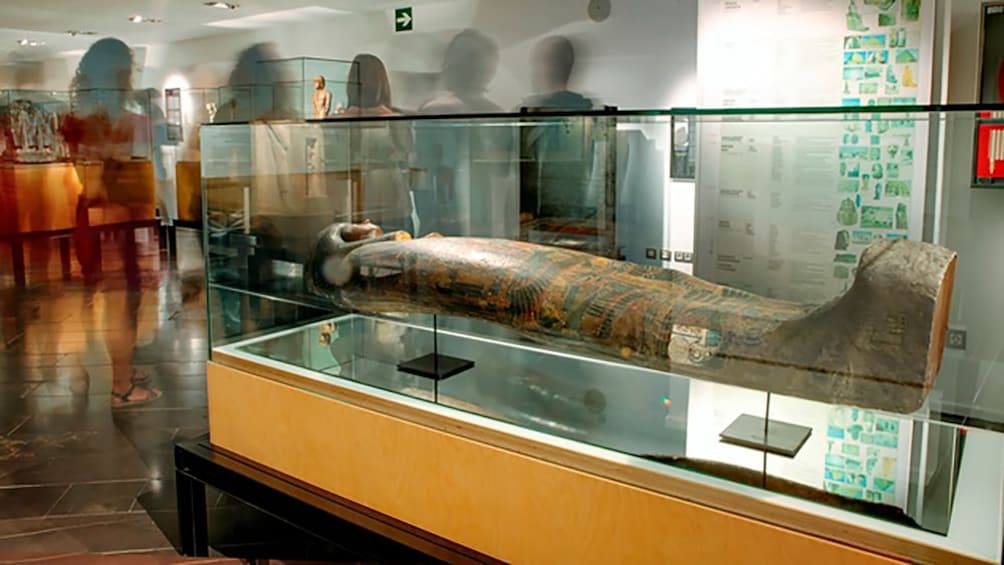 ancient sarcophagus behind class case at the museum in Barcelona