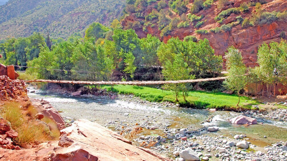 a wooden suspension bridge across the water in Morocco