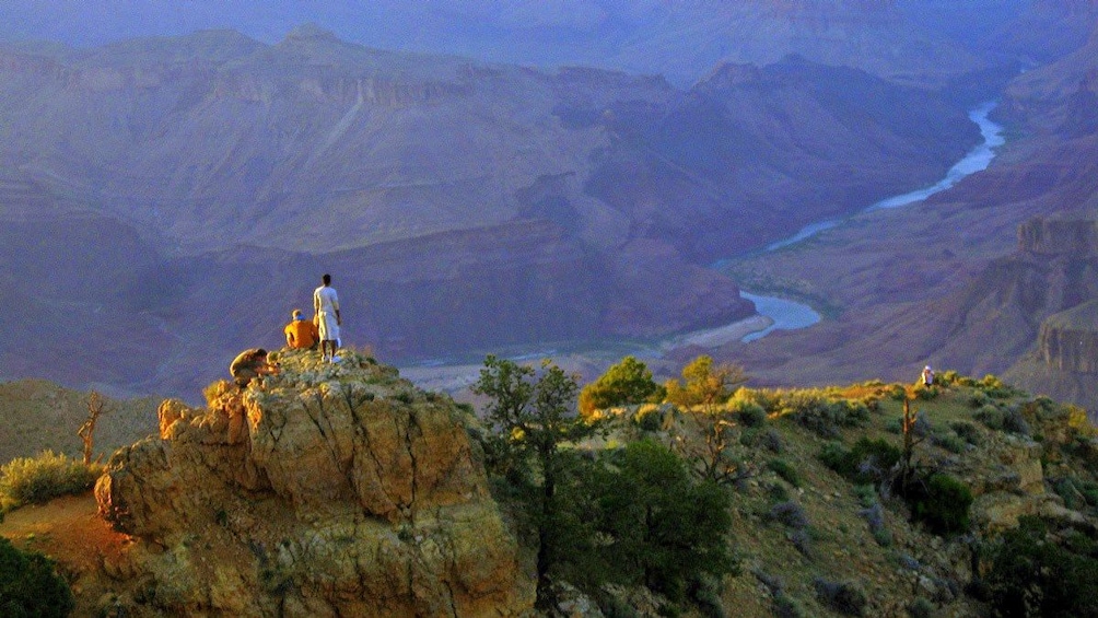 men standing on the top of the mountain in Grand Canyon