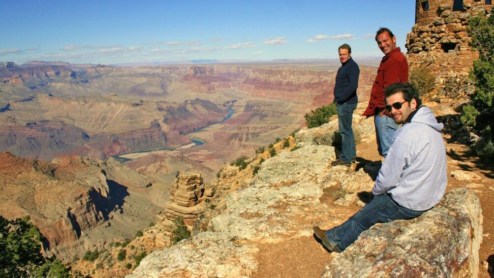 men standing near the edge of a tall cliff in Colorado