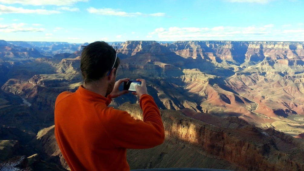 Man takes a picture of the Grand Canyon