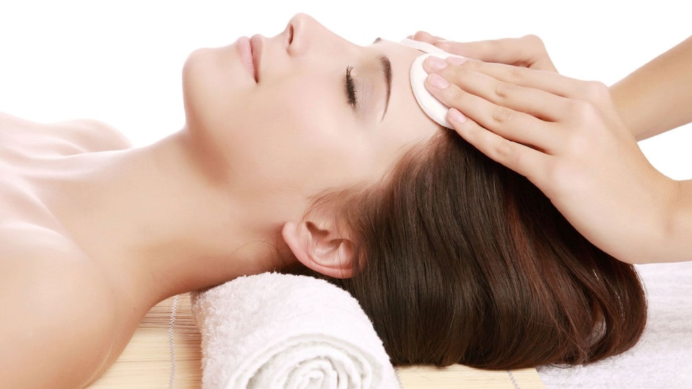 woman receiving a forehead massage at the spa in Seattle