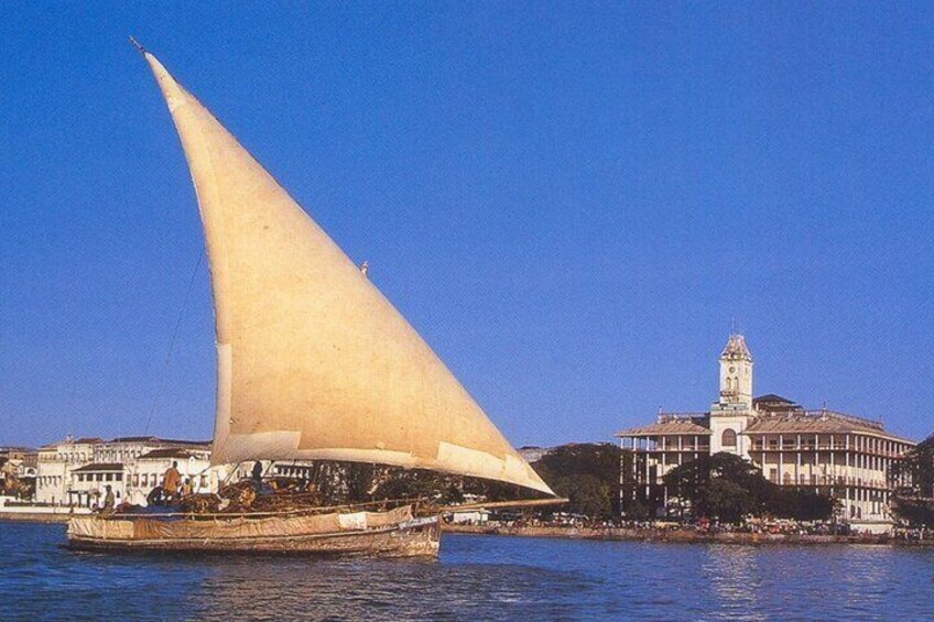 behind the sailing Dhow you might see the a very beautiful building with minaret tower on top along with huge history 