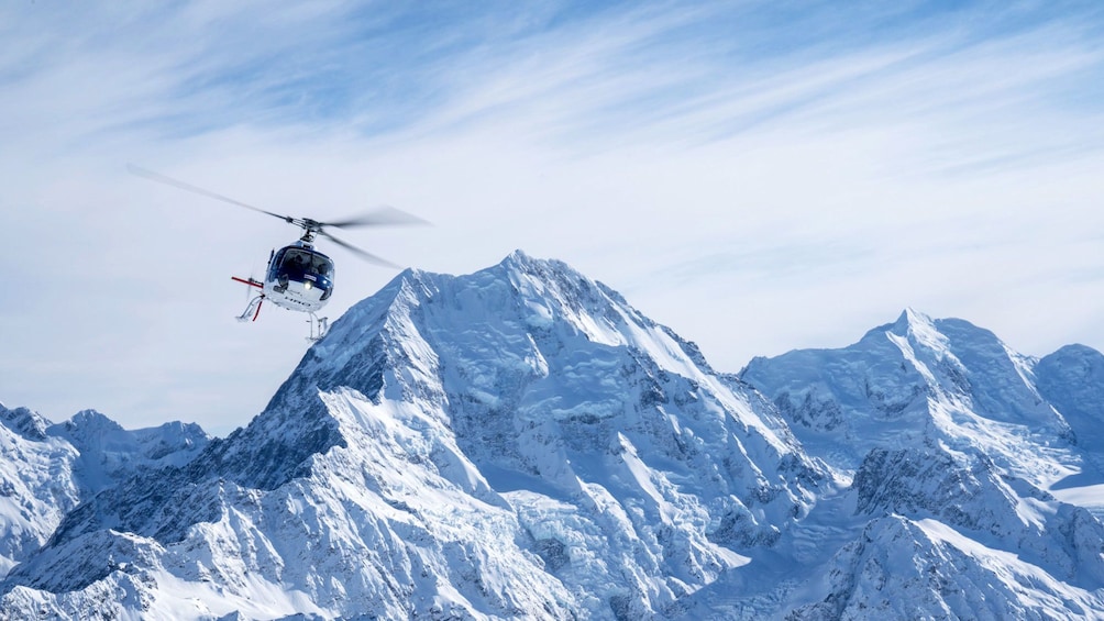 Helicopter flying with Mount Cook in background in New Zealand