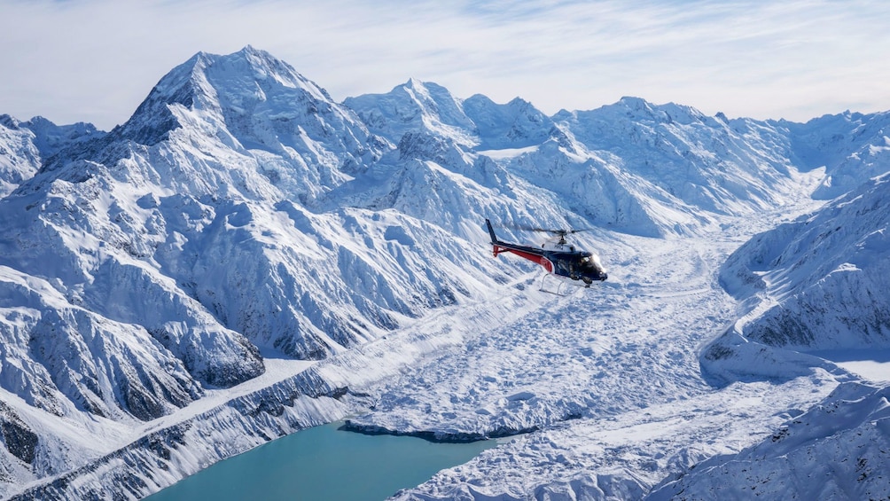 Helicopter flying over glacier and Mount Cook in New Zealand