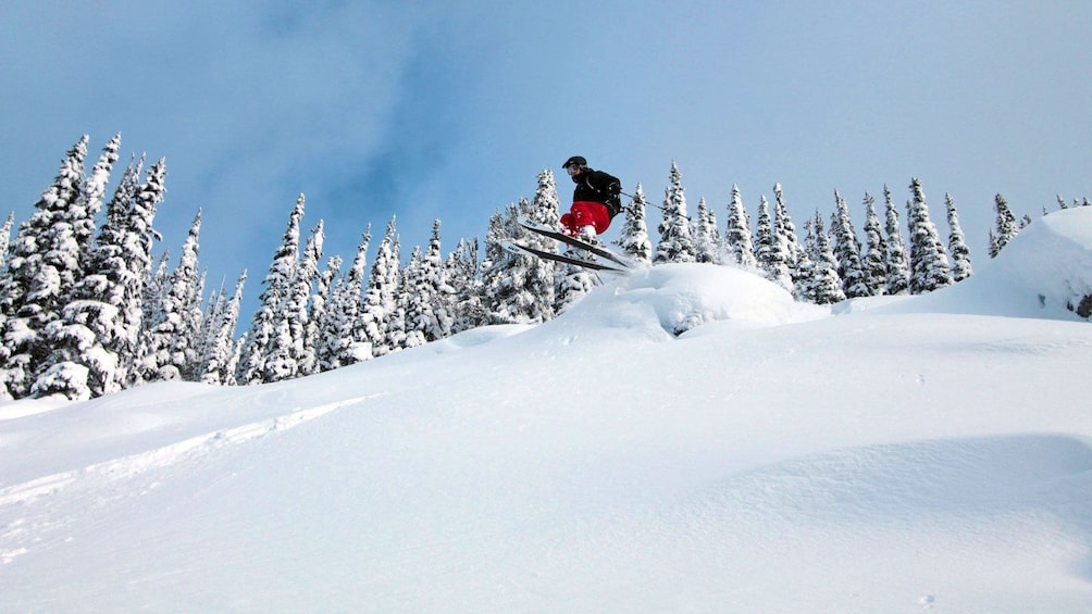 Show item 3 of 7. skier speeding off a ramp in Whistler