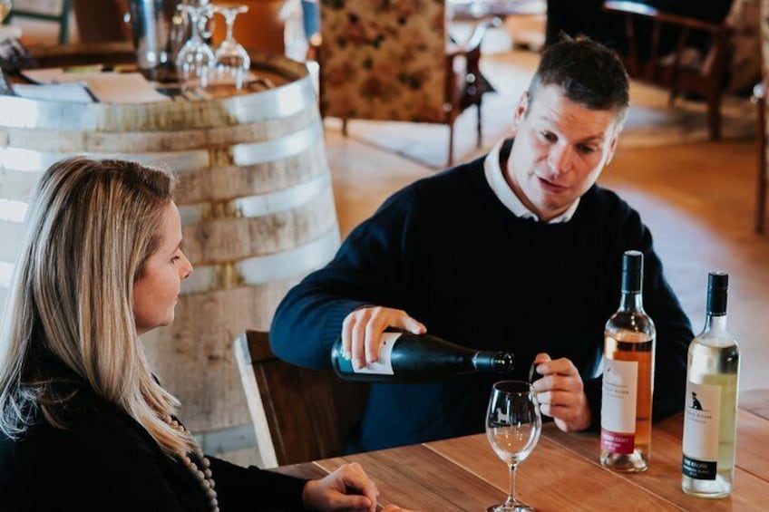 Steven Raidis tasting wine with a customer.