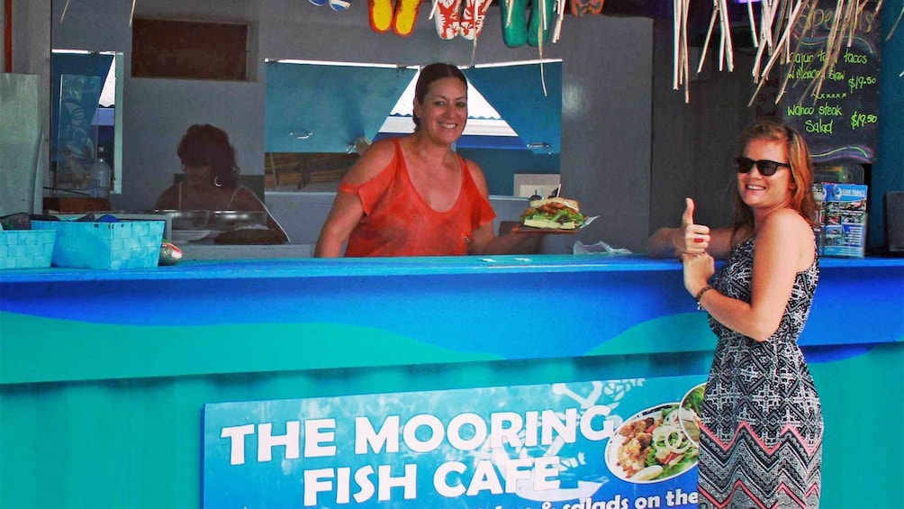 Woman getting a plate of food in the Cook Islands 