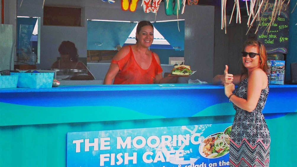 Woman getting a plate of food in the Cook Islands 