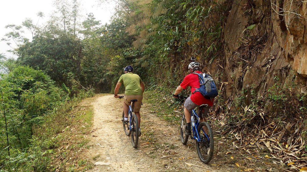 Two people on a biking tour of Mai Chau Valley in Vietnam 