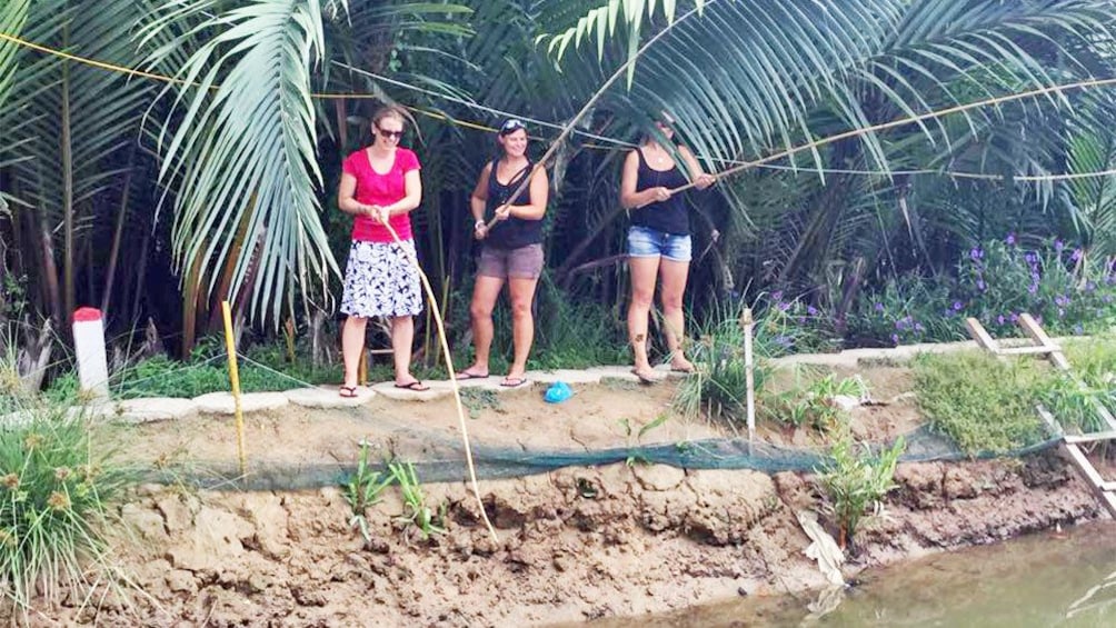 Tourists learning how to fish in Hoi An, Vietnam 