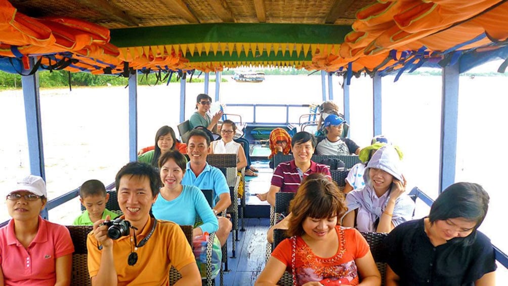 People having fan on tour boat in Ho Chi Minh City