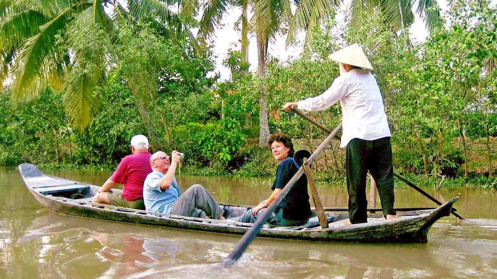 small group on a small wooden raft in Vietnam