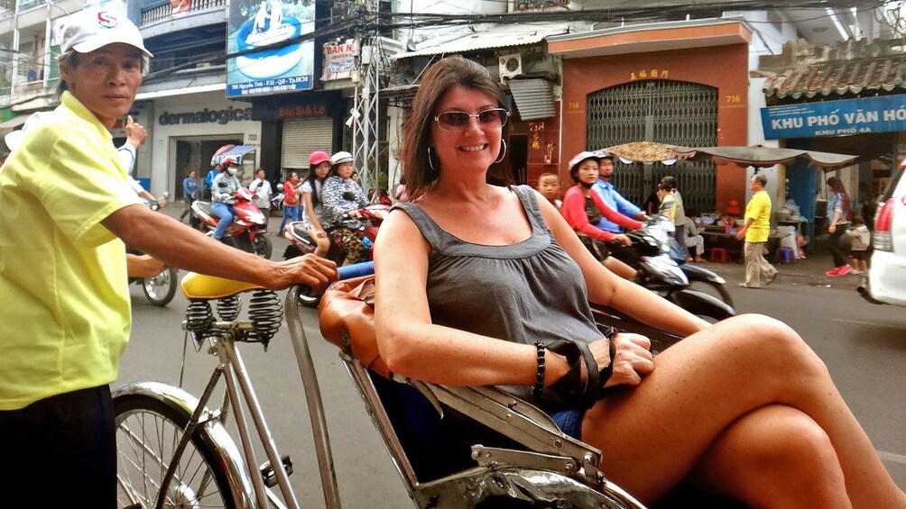 woman riding in a cyclo in Vietnam
