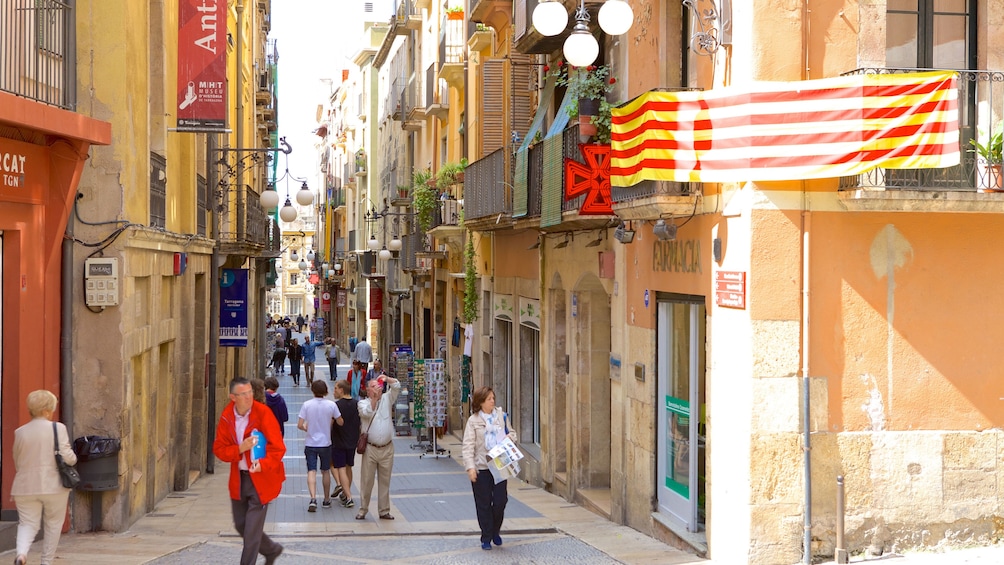 People walking down a narrow street in Sitges