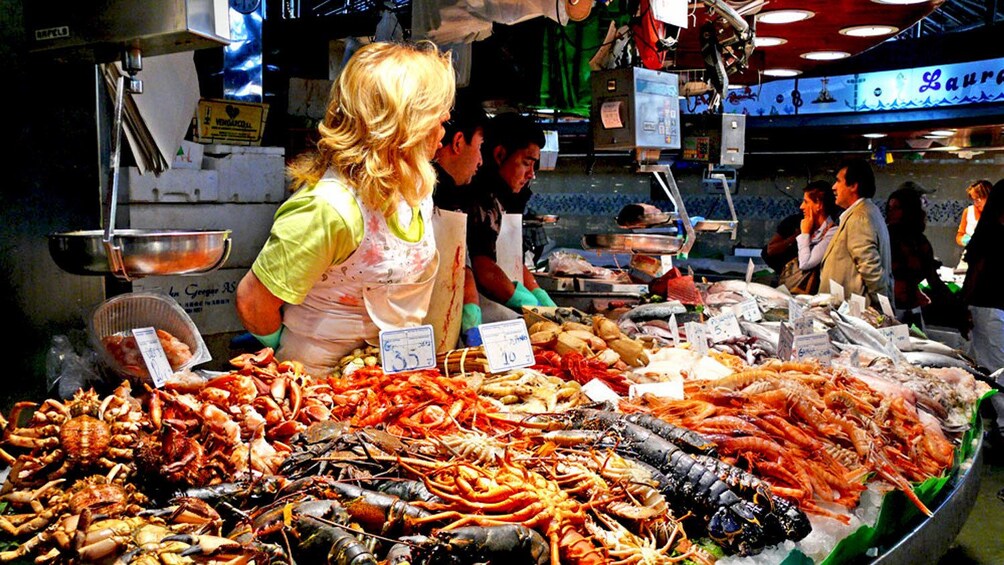 woman selling seafood at market in Barcelona