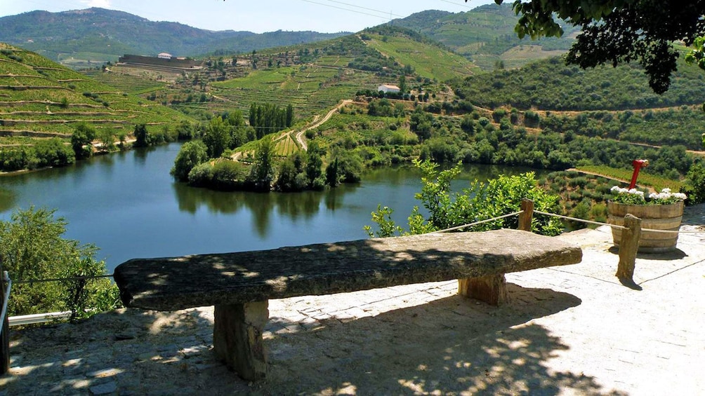 a stone bench overlooking the hills in Porto