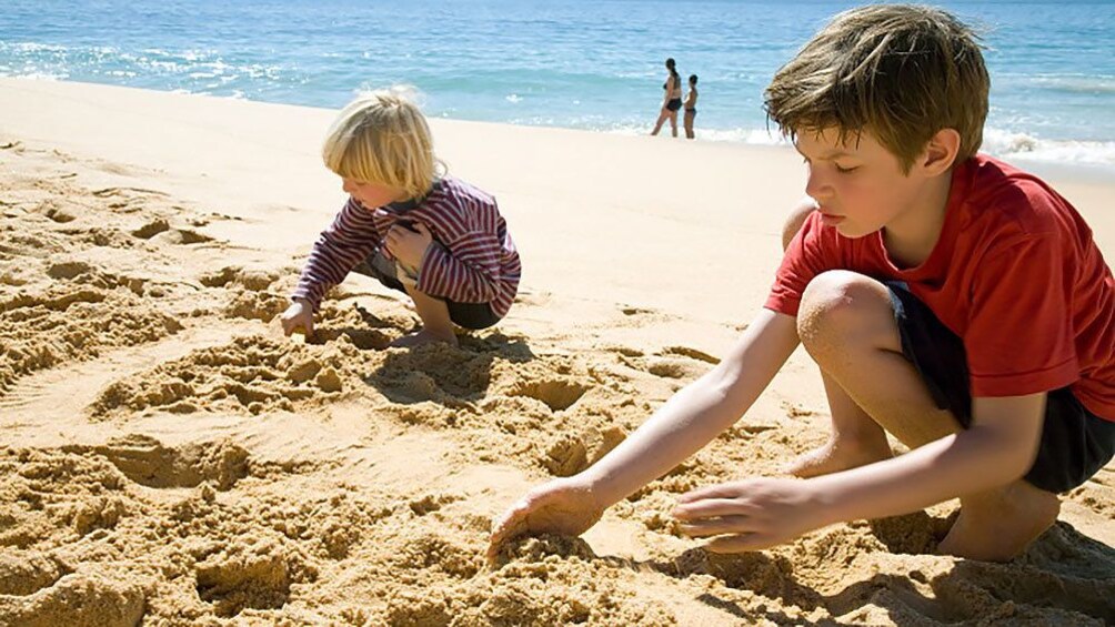 children playing with sand at the beach in Lisbon