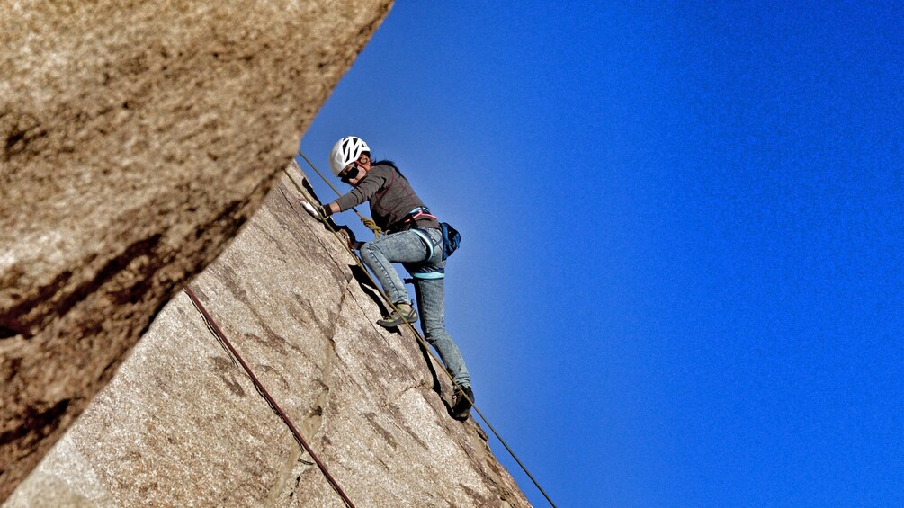 Show item 4 of 5. Rock climber on rock face in Ontario