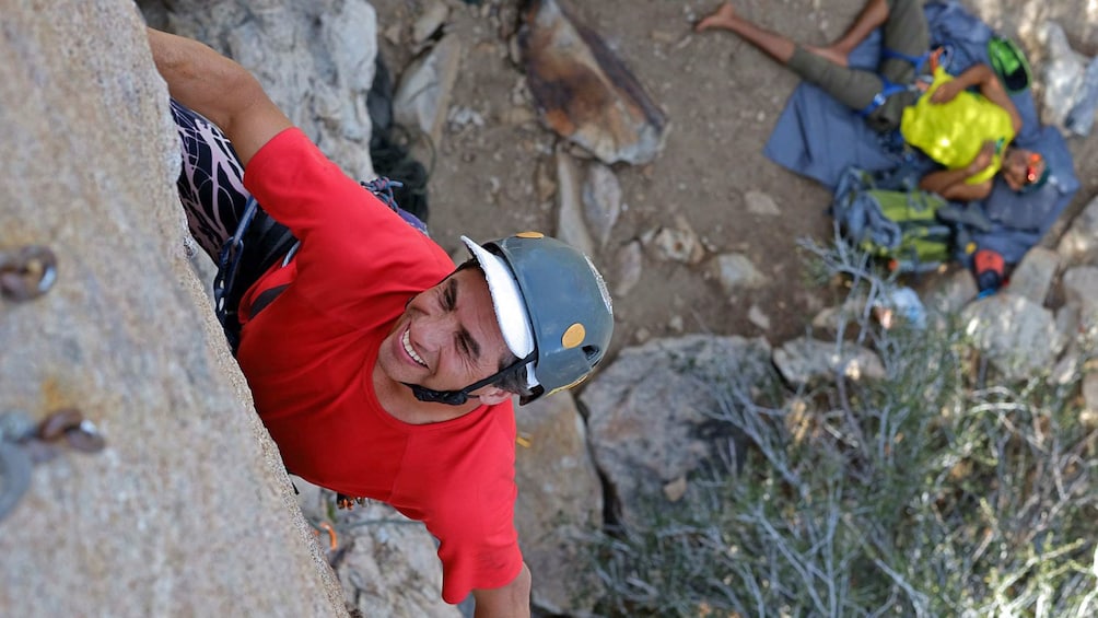Show item 4 of 5. Rock climber in red shirt in Palm Springs