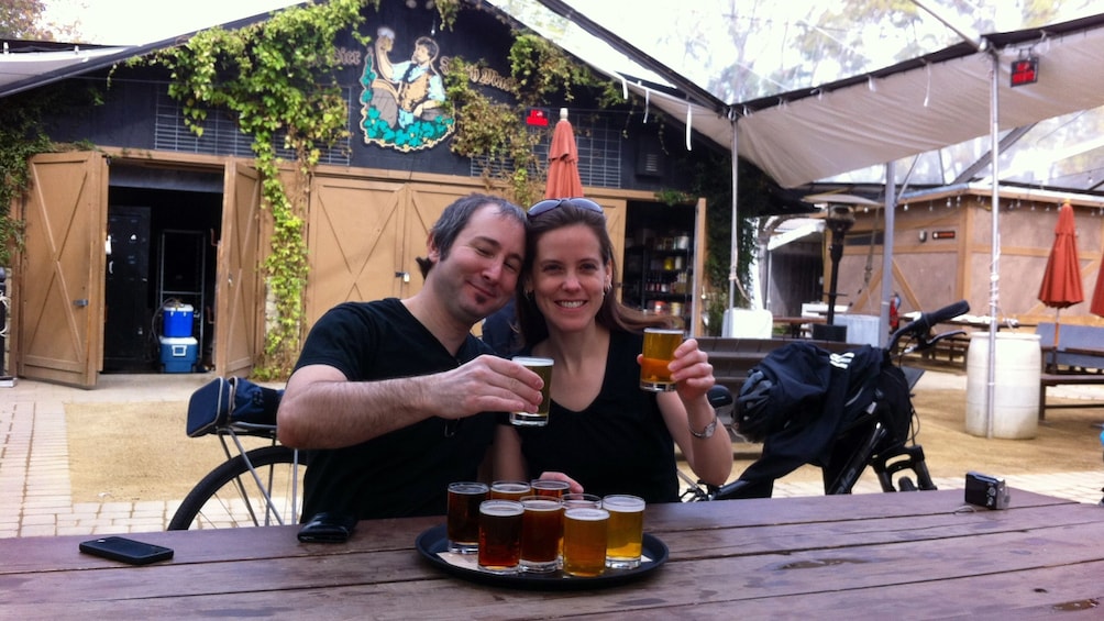 Couple toasting with beer samples
