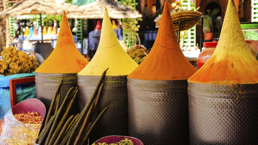 Marrakech spice market with barrels of spice and herbs