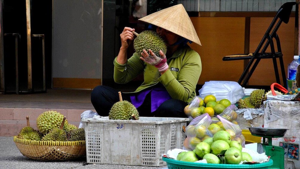 Woman eating a durian in Ho Chi Minh City 