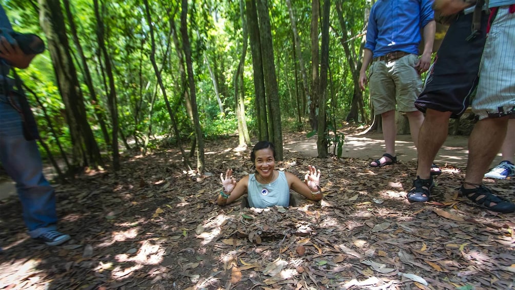 Woman exiting the  Cu Chi Tunnels in Vietnam 