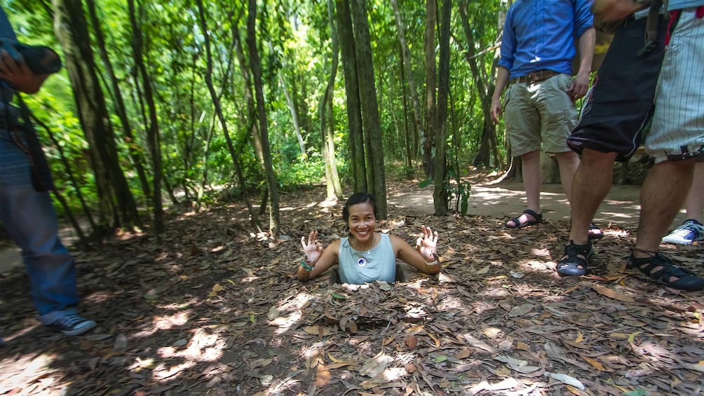 Woman exiting the Cu Chi Tunnels in Vietnam
