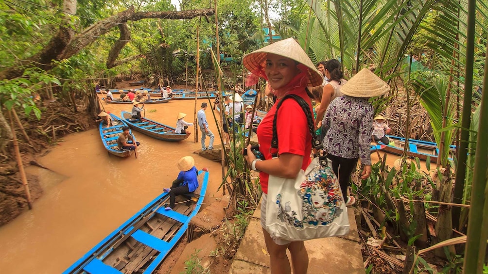 Tourists wearing straw hats getting ready for a river tour in Vietnam 