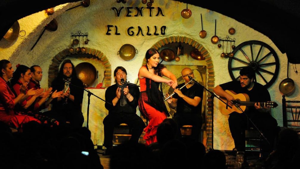 Flamenco dancer with musicians onstage in Granada