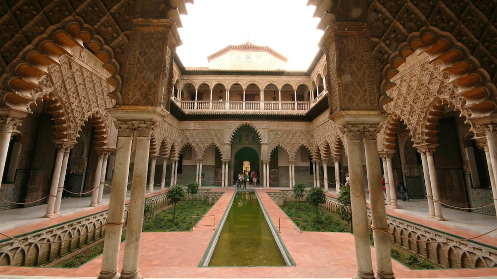Interior courtyard of a place with garden and reflecting pool in Granada