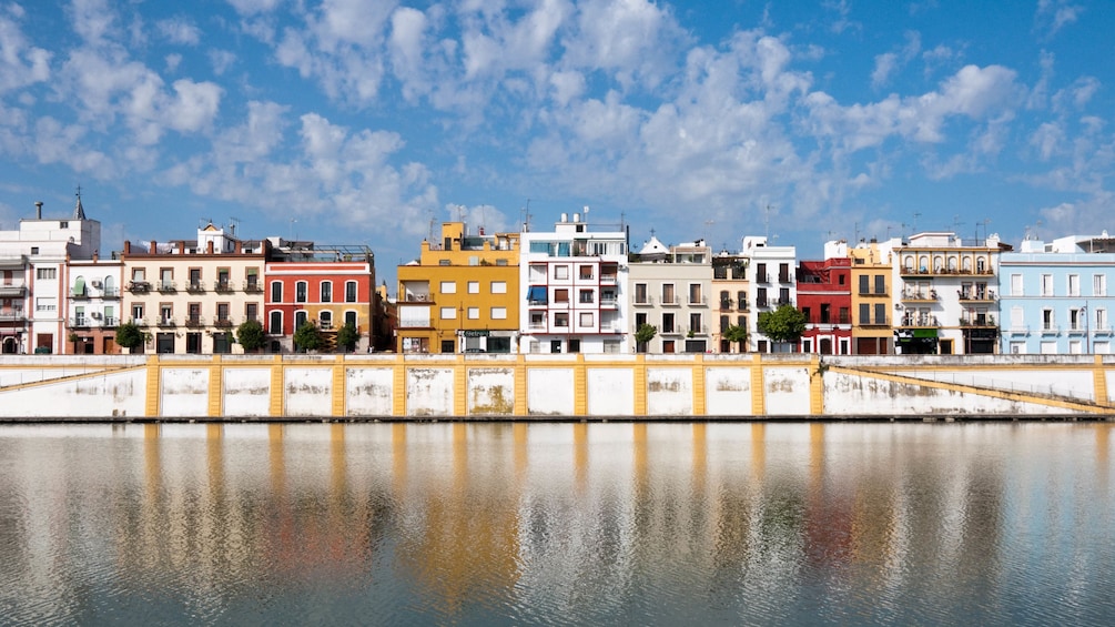 Landscape of Guadalquivir river with several buildings in view.