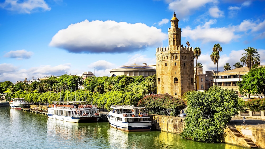 Landscape of Guadalquivir river area with several buildings in view.