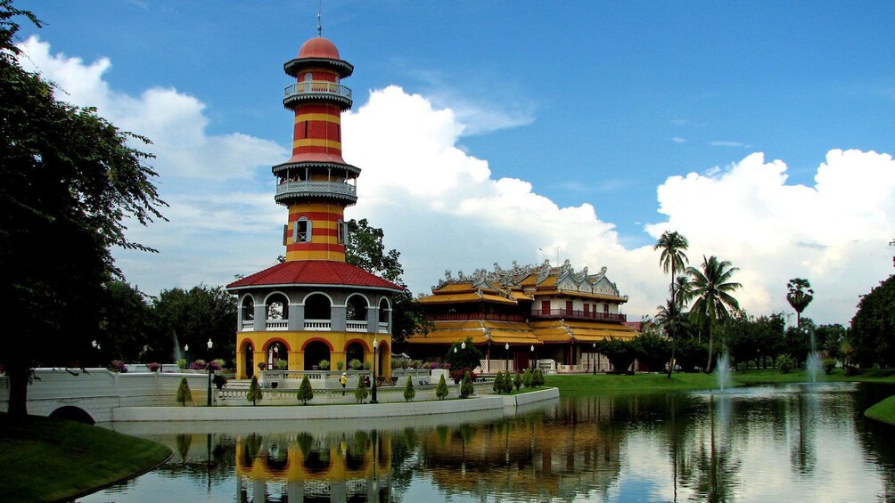 แสดงภาพที่ 3 จาก 5 a tall pagoda near a body of water in Thailand
