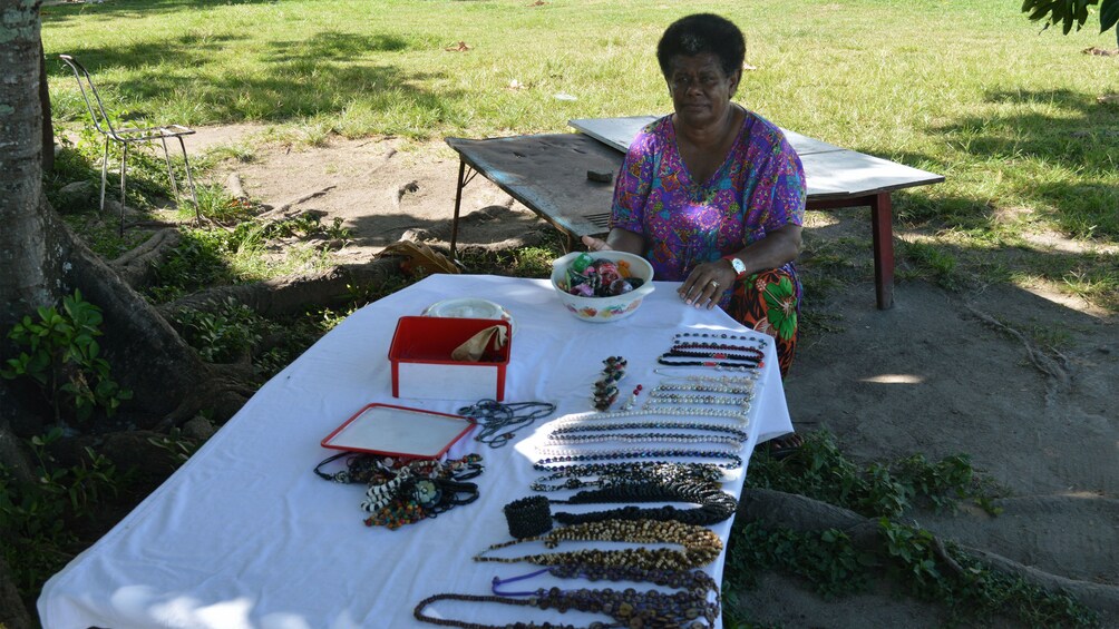 Woman at table of jewelry in Fiji