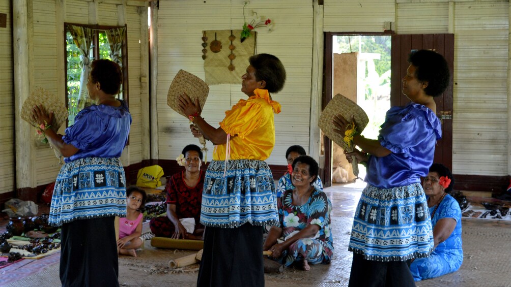 Women dancing with fans in Fiji