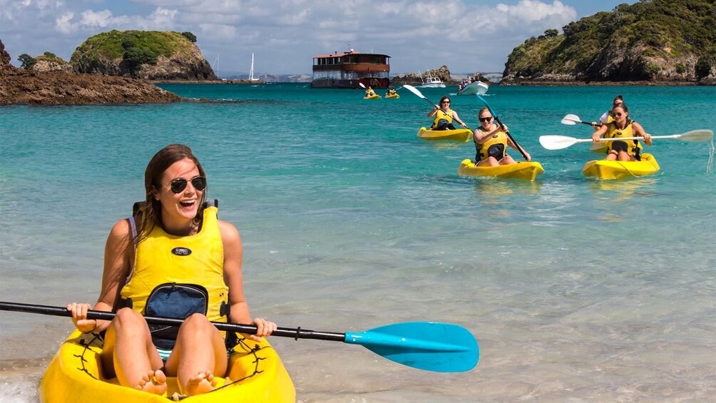 Group having fun kayaking in the Bay of Islands, New Zealand