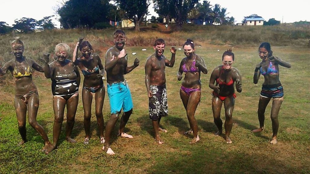 Group of people covered in mud in Fiji