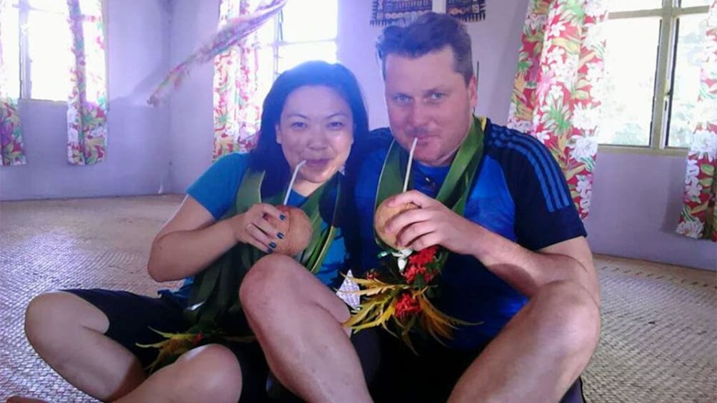 Couple drinking coconut cocktails in Fiji