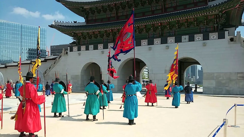 people in colorful robes with flags