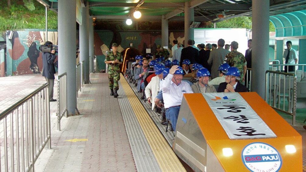 people in seats of trolley in seoul 