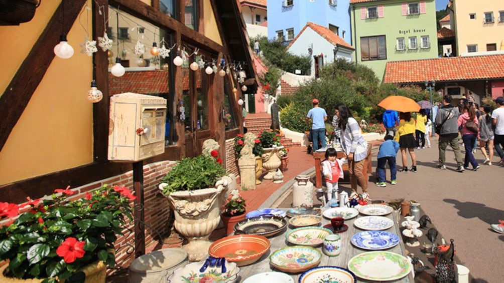 town scene with pottery and wandering people