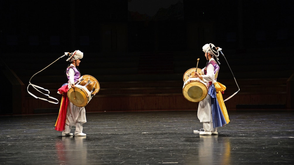 people with drums doing ribbon dance