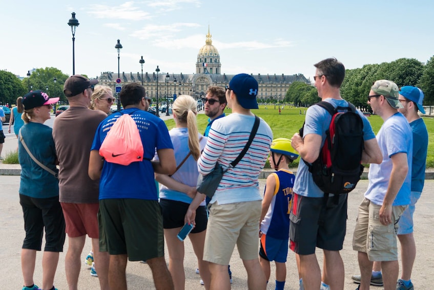 Tour group gathers in front of large building