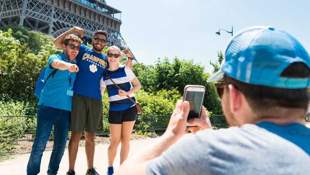 Group poses for photo at the base of Eiffel Tower