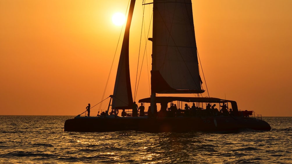 People viewing sunset on catamaran in Santorini