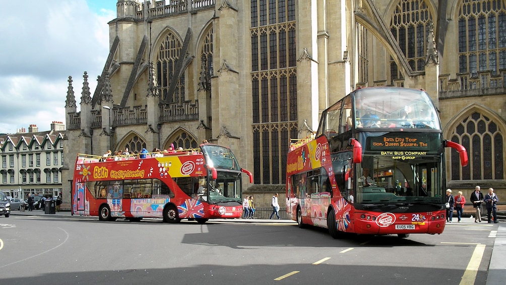 Show item 3 of 10. Pair of Hop-On Hop-Off buses in Bath